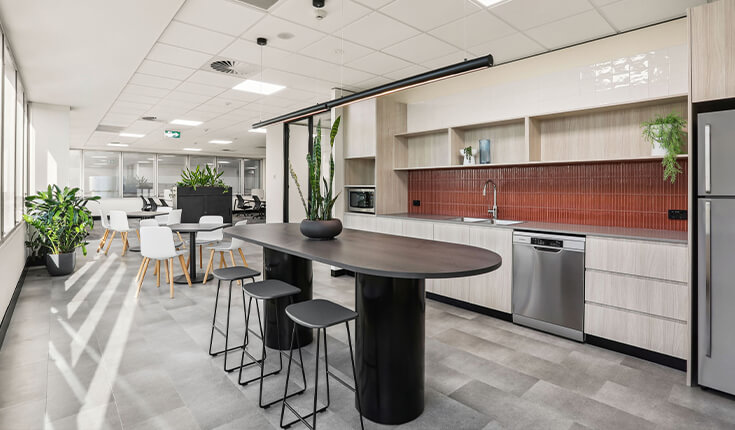 Modern office pantry at 33 Argyle Street, Sydney, Australia with island table and appliances