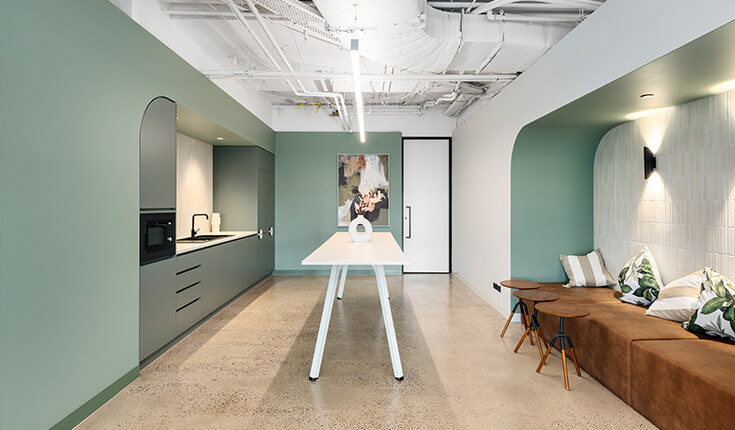 Modern office pantry at 312 St Kilda Road with lounge seating and table