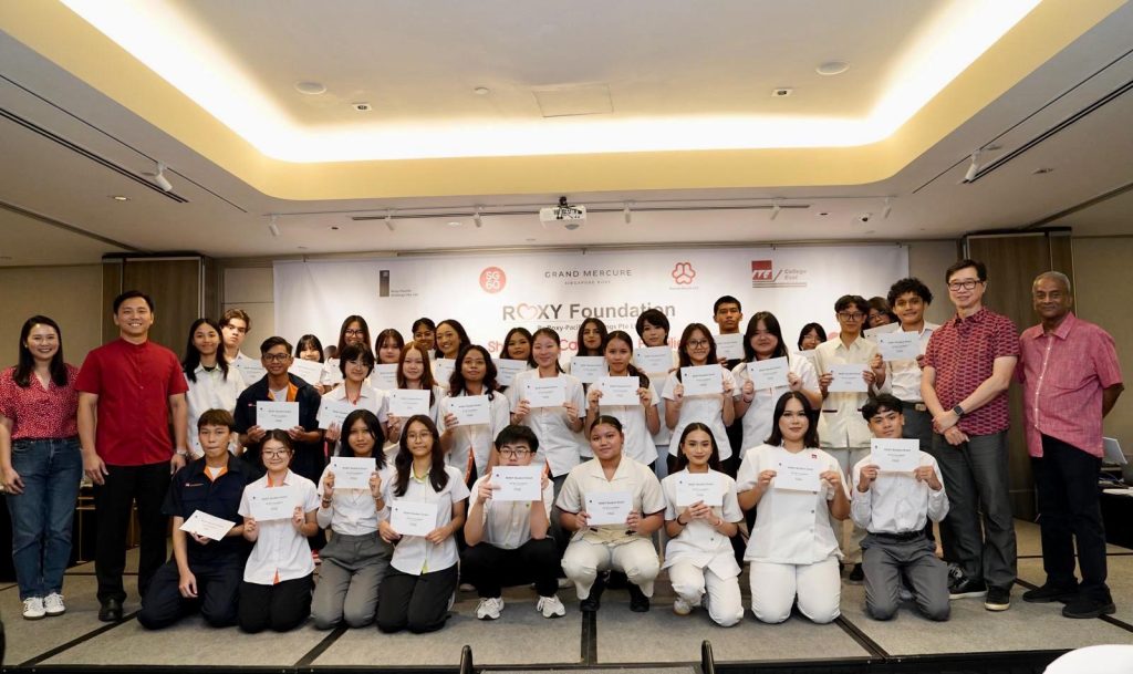 Roxy Foundation youth programme participants holding certificates at community event