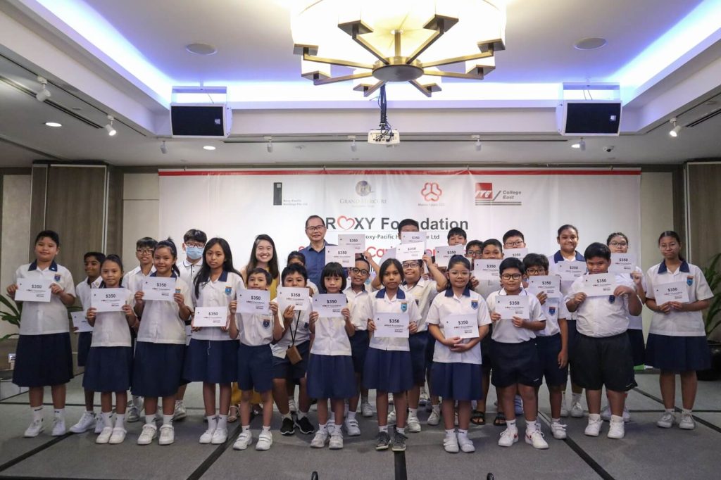Students posing with certificates at an indoor event