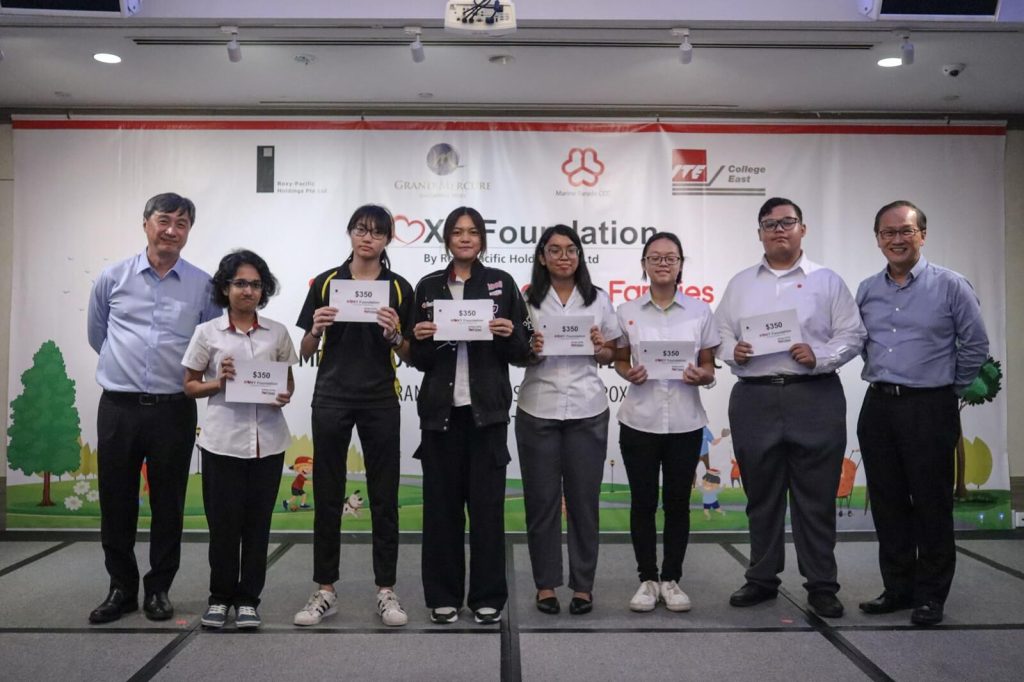 Students holding certificates with facilitators at a foundation programme