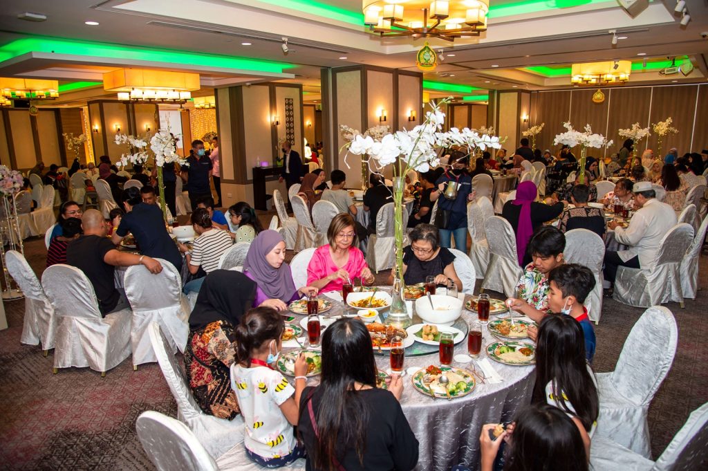 Residents breaking fast together at a Ramadan community dinner event