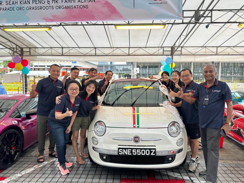 Roxy Foundation volunteers washing car during community charity car wash event
