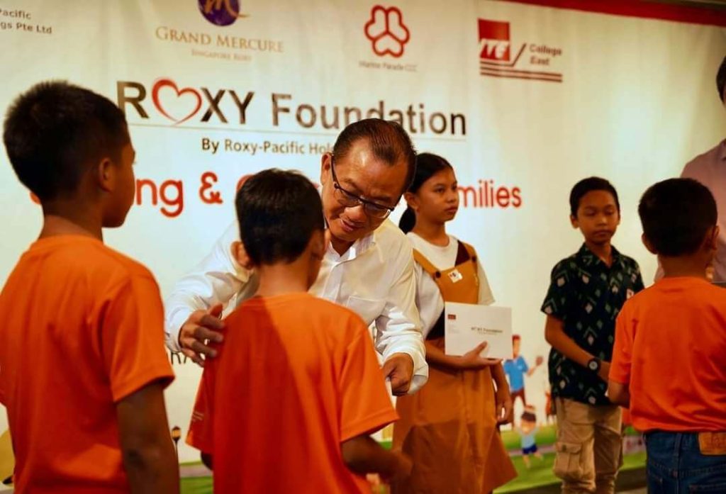 Roxy Foundation volunteers engaging with children at community outreach event