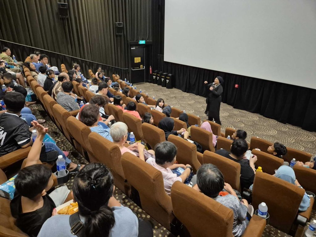 Roxy Foundation community screening event with families seated in cinema auditorium